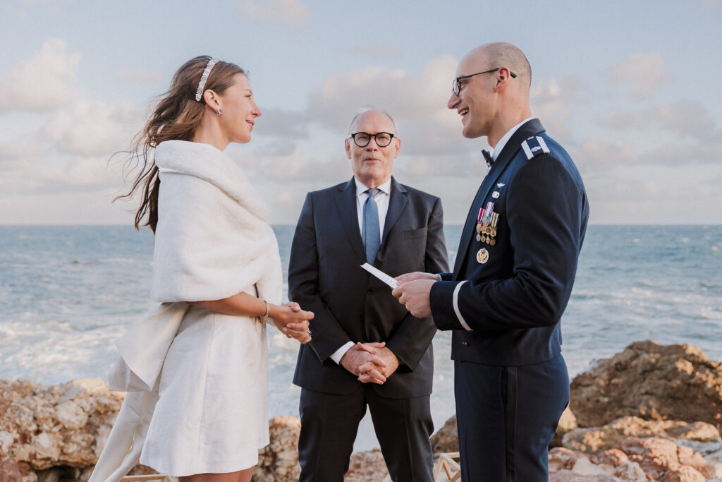 Wedding officiant with the bride and groom on the palos verdes shores at terranea resort