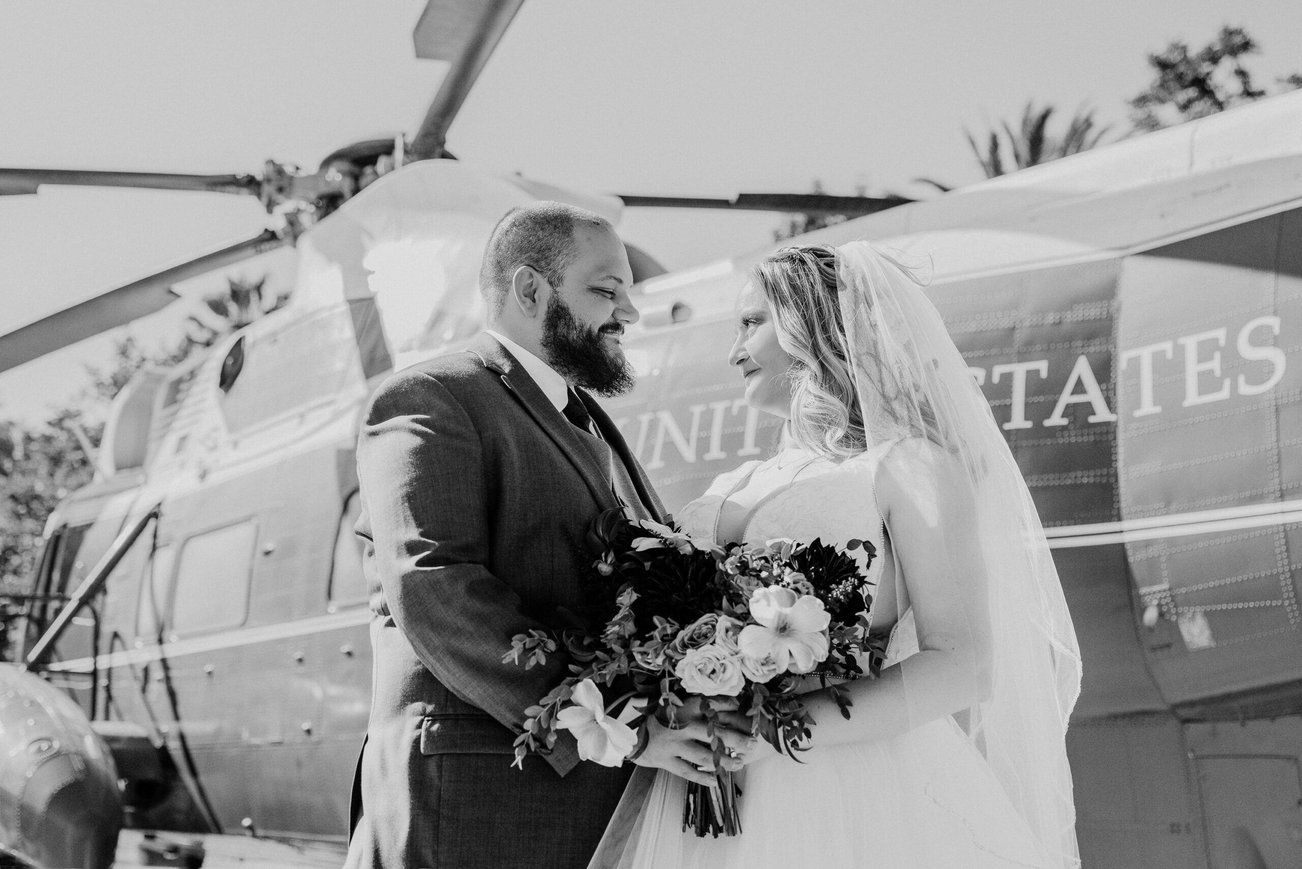 Black and white image of bride and groom at nixon library helipad during their wedding day