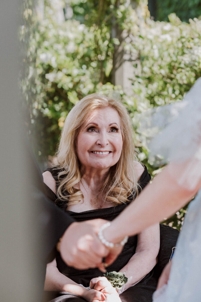 proud mother at first look with the bride