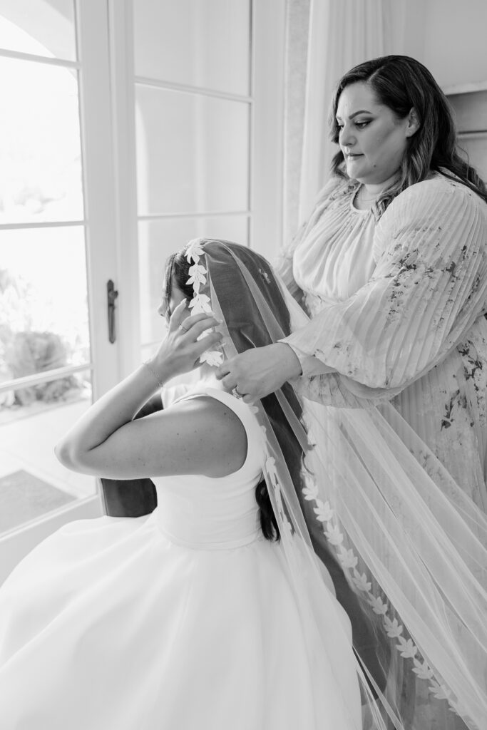 editorial image of bridal details putting on veil at terranea resort