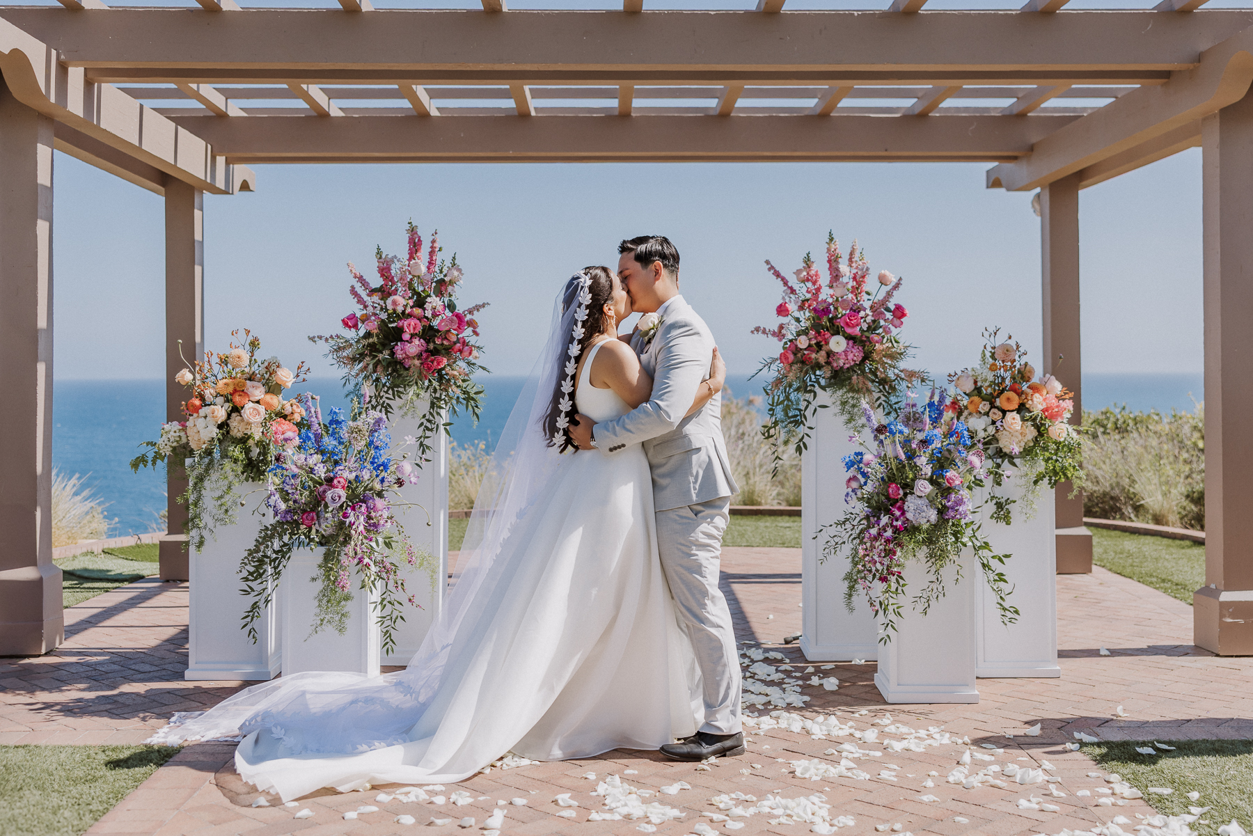 terranea resort wedding ceremony with whimsical flower pillars