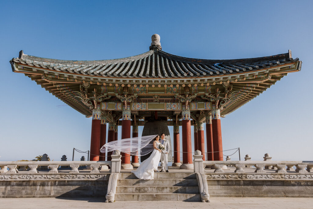 korean friendship bell photoshoot with bride and floating veil