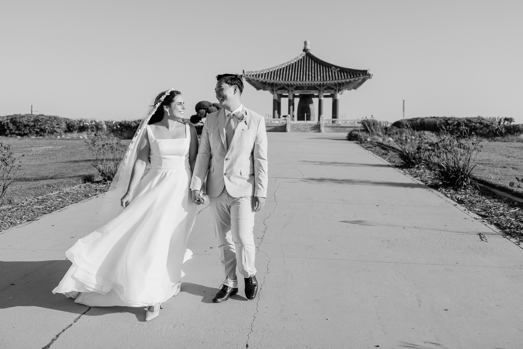 candid image of couple walking during photoshoot near palos verdes at the korean friendship bell