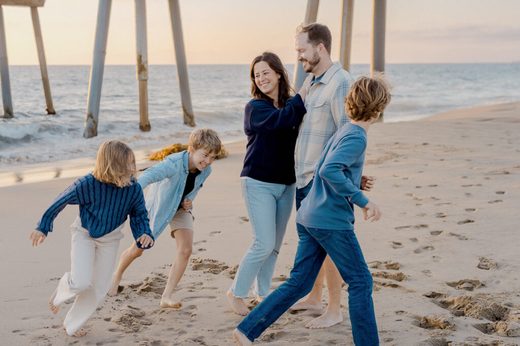 manhattan beach family session with tweens at golden hour, candid being playful.